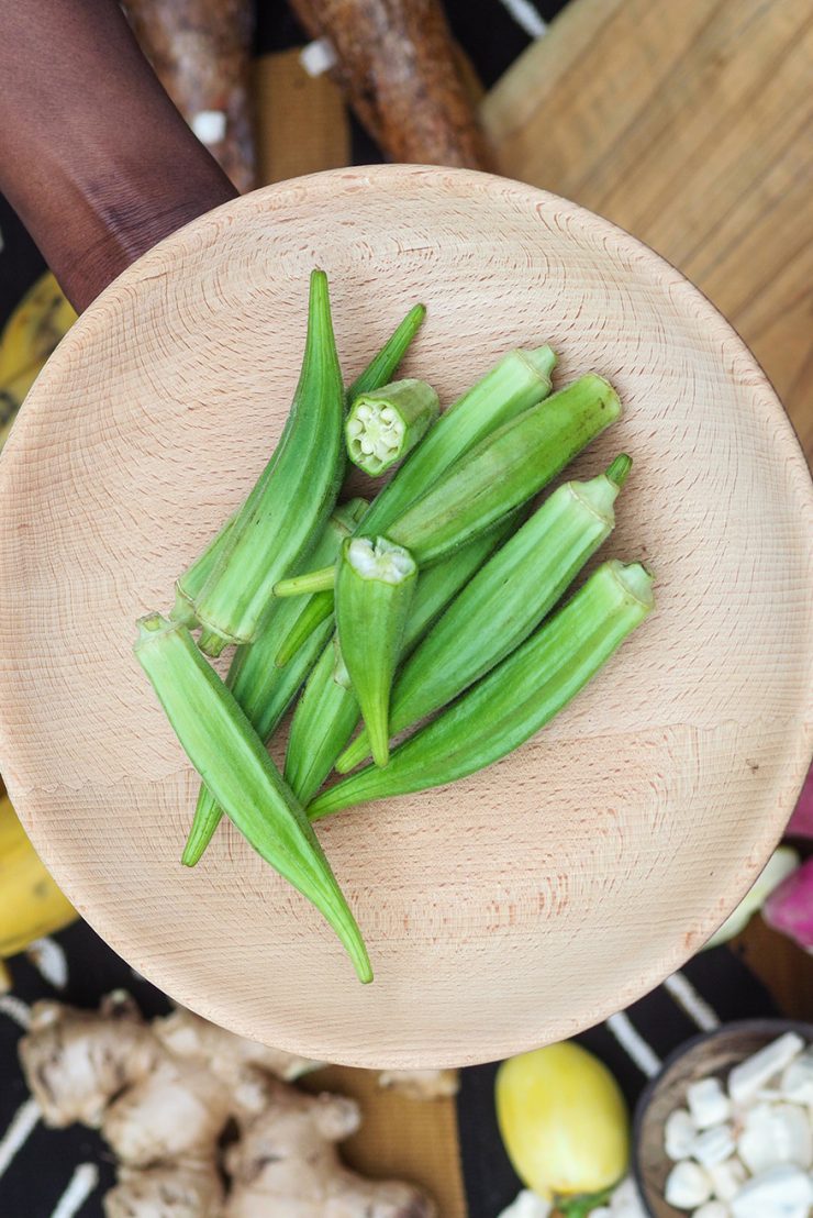 african-woman-chopping-okra-fruit-overhead-2023-11-27-05-33-56-utc
