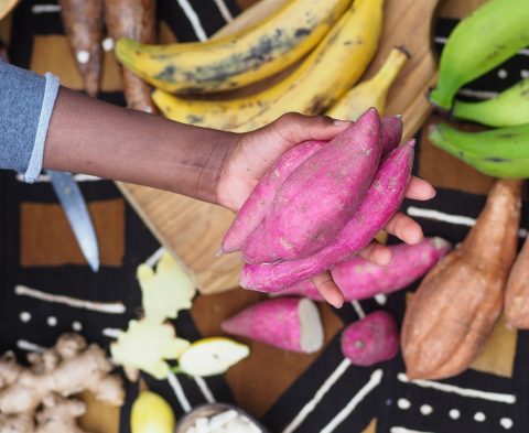 black-woman-holding-african-red-sweet-potato-2023-11-27-04-52-32-utc