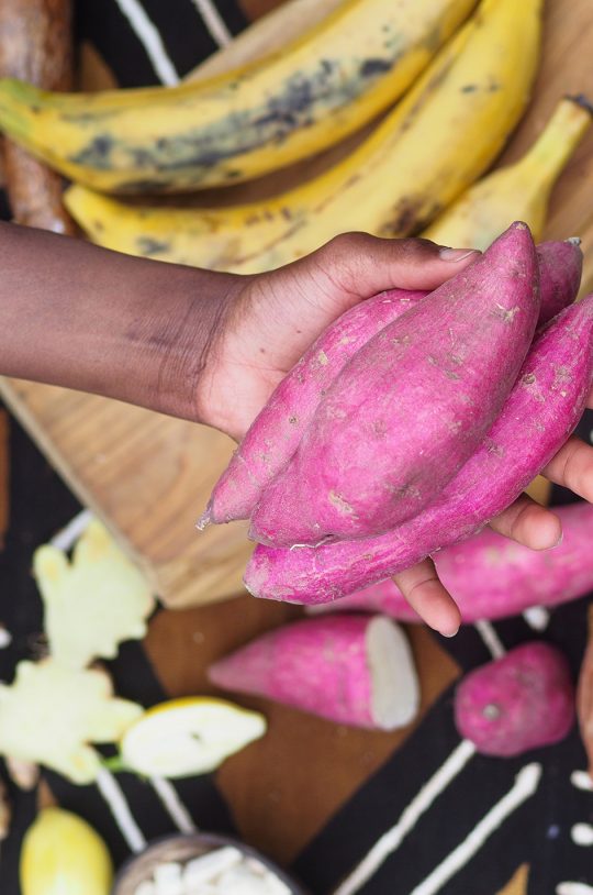 black-woman-holding-african-red-sweet-potato-2023-11-27-04-52-32-utc